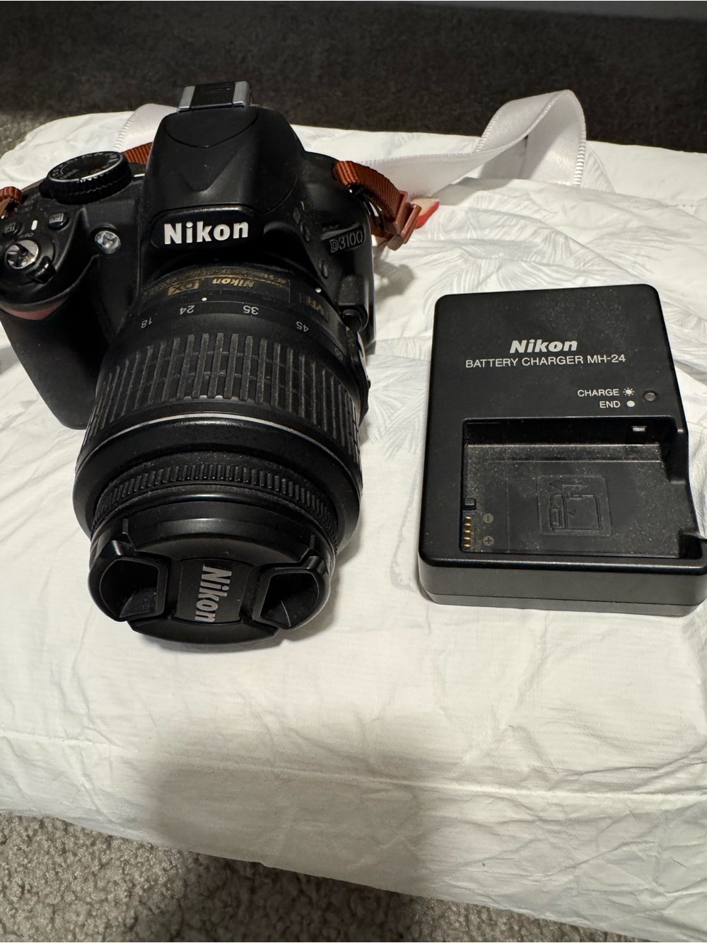 Nikon DSLR Camera with Black Lens and Black Charger
